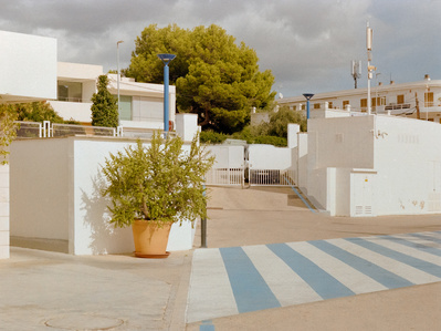 Geometrically interesting photo of a crosswalk in front of white buildings. Hasselblad 500CM, Kodak Gold 200.