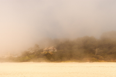 Cinematic shot of a foggy landscape with a small lake in the Pacific North West.