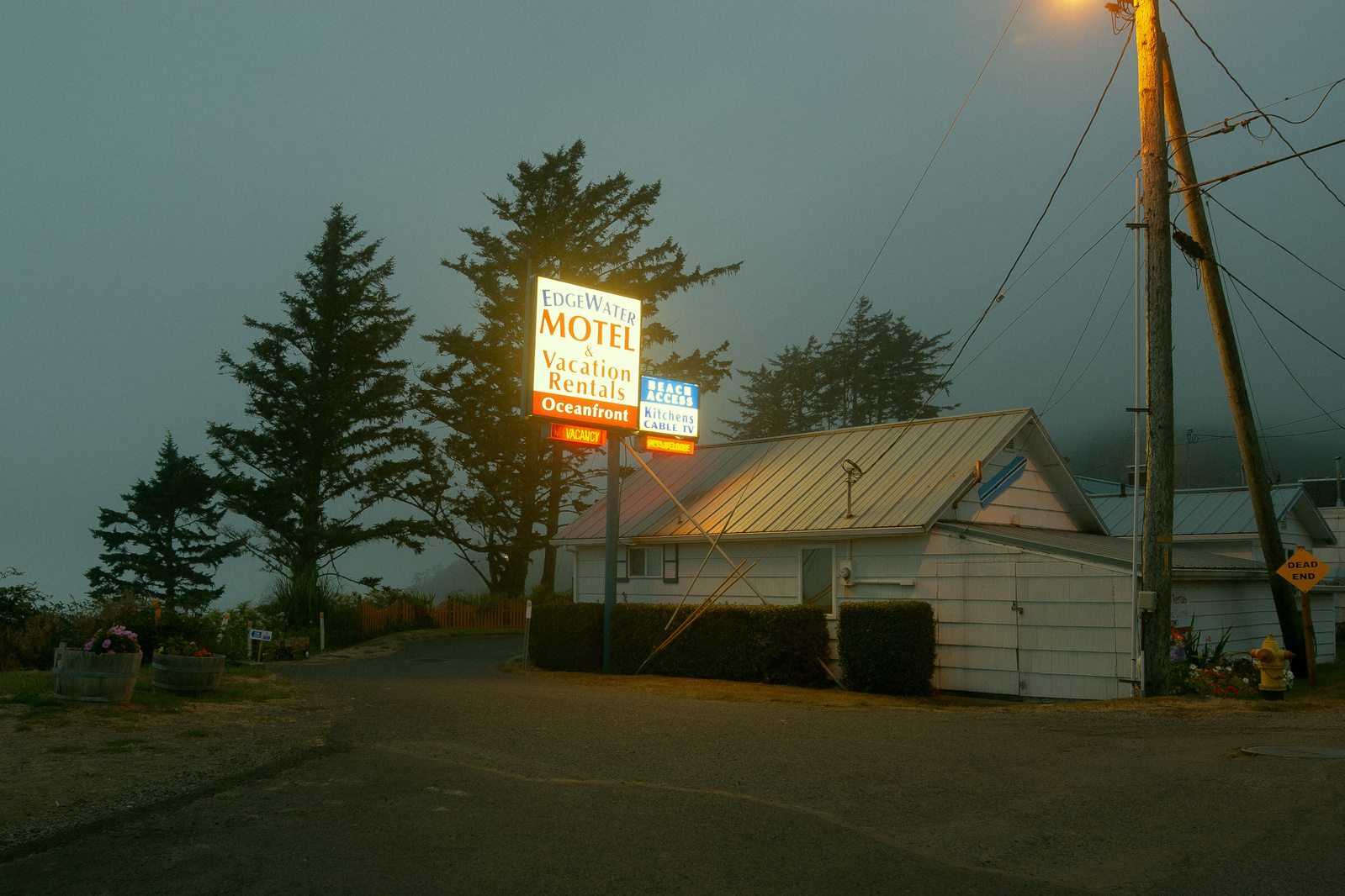 Cinematic and moody scene of a motel with a neon sign in Oregon.