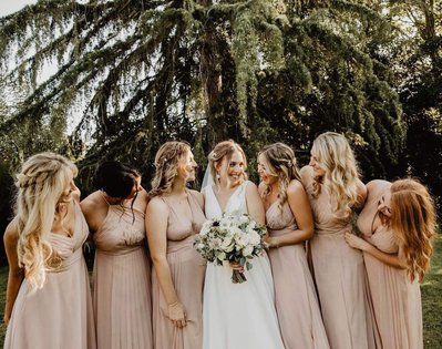 Bride and her bridal party wedding hair and makeup in the summer 