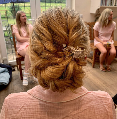 Bridesmaid hair textured low bun up do