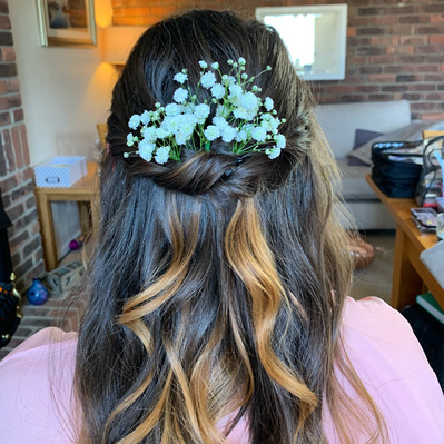 Bridesmaid half up half down hair with a twist detail and white flowers