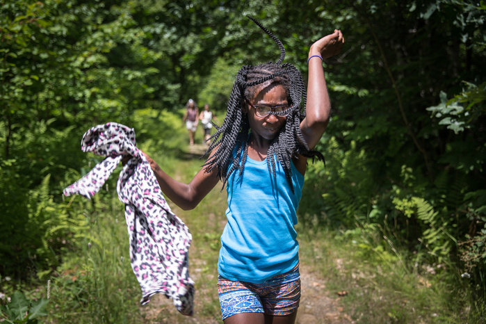 Brianna George, 11, of Fort Greene, Brooklyn, swats bugs away while hiking back with the Martin family, on a trail from the High Ledges in Shelburne Falls, a popular scenic overlook, Thursday, July 12. While swatting away bugs, Brianna repeatedly asked, "