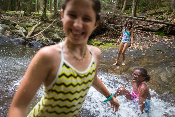 Katie Martin, 12, Brianna George, 11, and Allie Martin 9, play in a small pool at the bottom of a waterfall at Chapel Brook Falls in Ashfield, Thursday, July 14. Brianna spent a week with the Martins, arriving Friday, July 8, as she has each summer for th