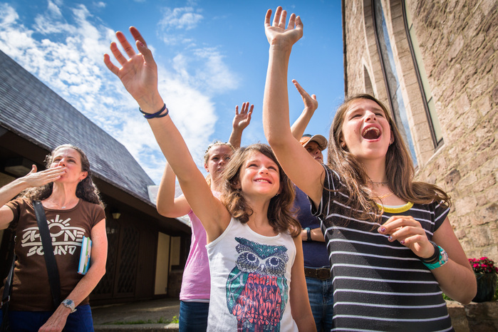 Jennifer Martin blows a kiss to Brianna George, 11, her daughters Allie Martin, 9, and Katie Martin, 12, waving goodbye as Brianna's bus leaves Saint James Episcopal Church in Greenfield, taking her back home to Fort Greene, Brooklyn at the end of her wee