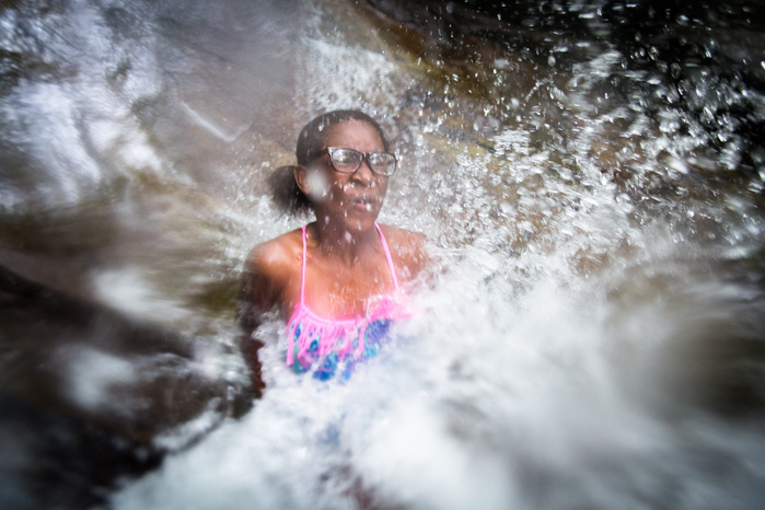 Brianna George, 11, of Fort Greene, Brooklyn, splashes into a small pool after sliding down a waterfall at Chapel Brook Falls, in Ashfield Tuesday, July 14. For the past six summers, Brianna has been hosted by the Martin family from Shelburne Falls as par