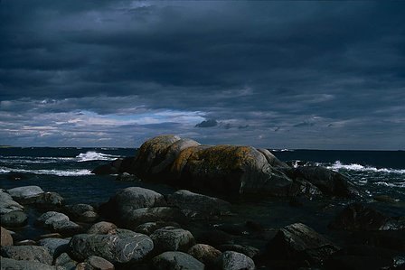 Smoothed piece of bedrock looking like a resting giant lady on the sea by the rocky island