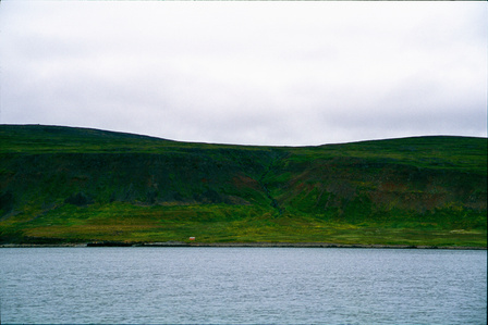 A safe house for seafarers resting on  seashore under green hills