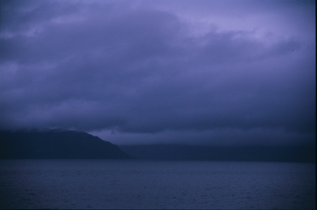 Dark sky over a remote fjord with wistling wind