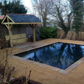 Garden landscaping with a water feature surrounded by hoggin path