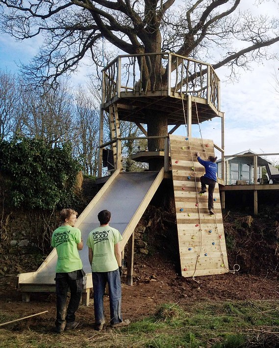 decked platform going into the playground area, with slide & climbing wall.
