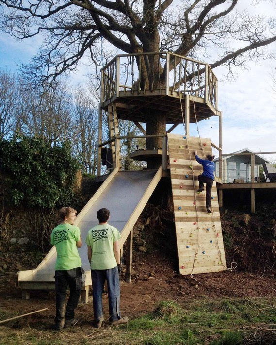 decked platform going into the playground area, with slide & climbing wall.

