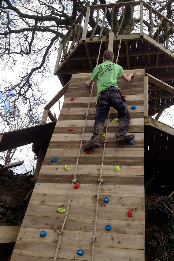 decked platform going into the playground area, with slide & climbing wall.
