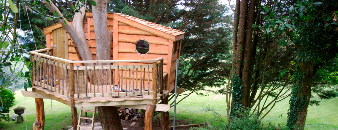 A treehouse sitting amongst trees on Dartmoor, Devon. Douglas Fir cladding, Chestnut balustrade & Cedar shingle roofing.