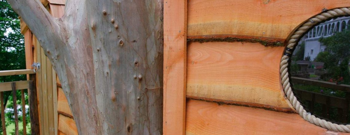 A treehouse sitting amongst trees on Dartmoor, Devon. Douglas Fir cladding, Chestnut balustrade & Cedar shingle roofing.