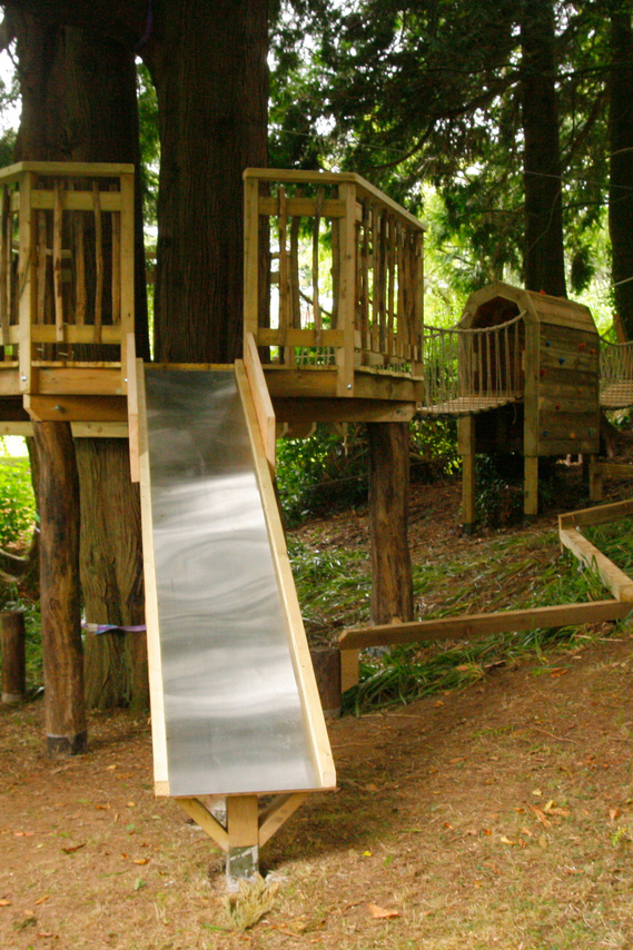 slide and wobbly bridge as part of an assault course in Devon woodland