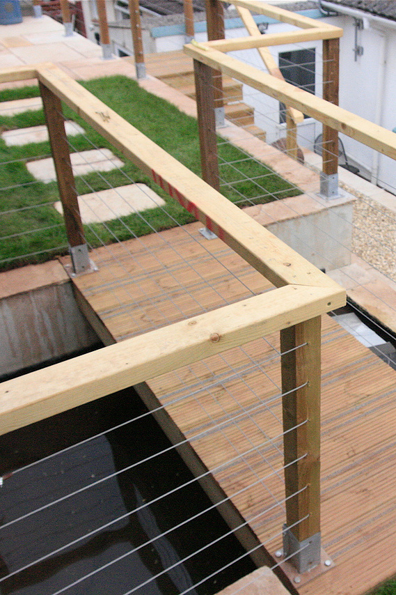 A contemporary area centered around a water feature, and using cantilever bridges. Design and build by Sam Bairstow of Seriously Good Landscapes