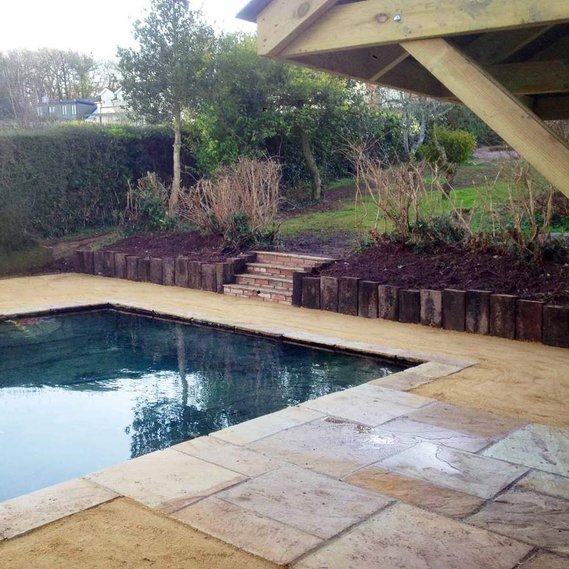 Garden landscaping in Devon, a hoggin path and reclaimed slates surrounds a water feature