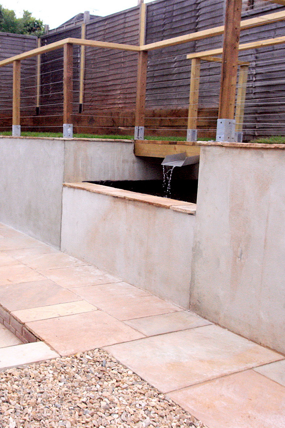 A contemporary area centered around a water feature, and using cantilever bridges. Design and build by Sam Bairstow of Seriously Good Landscapes