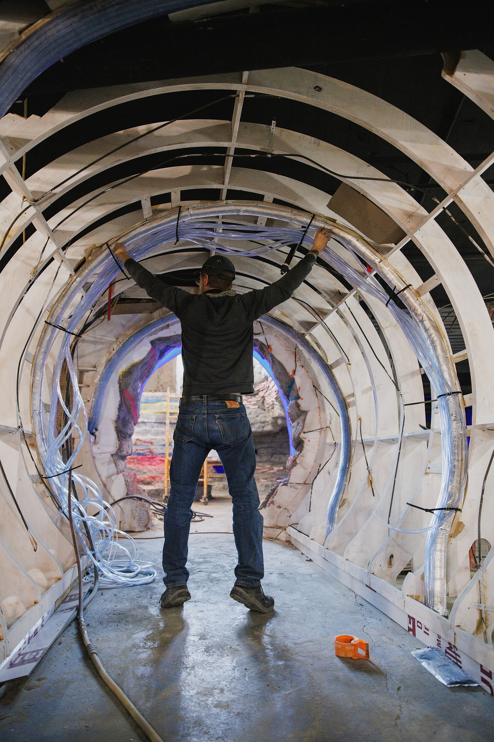 KANSAS CITY, MO – DECEMBER 07, 2023: A worker puts lighting through the space that will be a tunnel into The Rabbit Hole; an immersive museum in Kansas City, MO where people can experience scenes and characters from children’s literature. Credit: Chase Ca