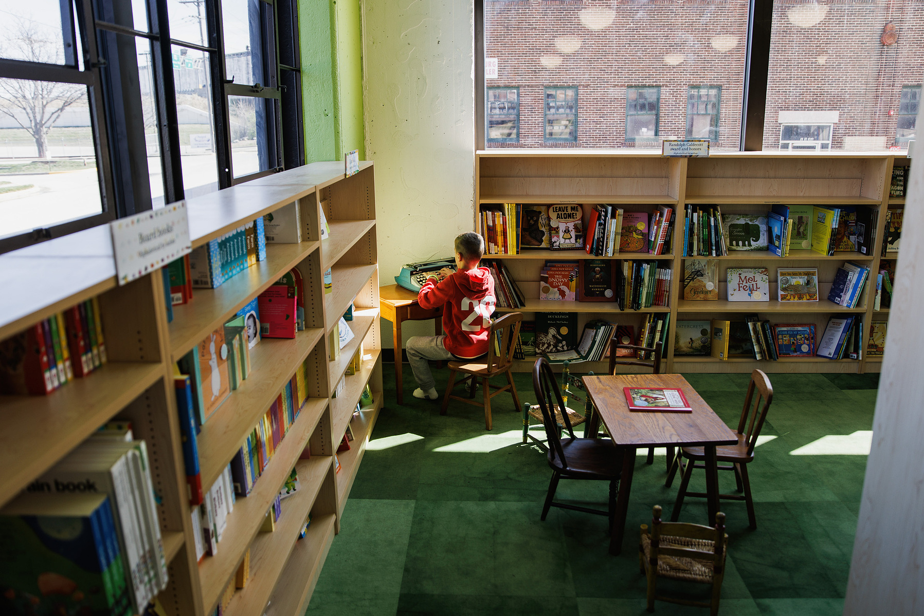 KANSAS CITY, MO – MARCH 16, 2024: A boy types on a typewriter in the bookstore at The Rabbit Hole in Kansas City, Missouri. Credit: Chase Castor for The New York Times.