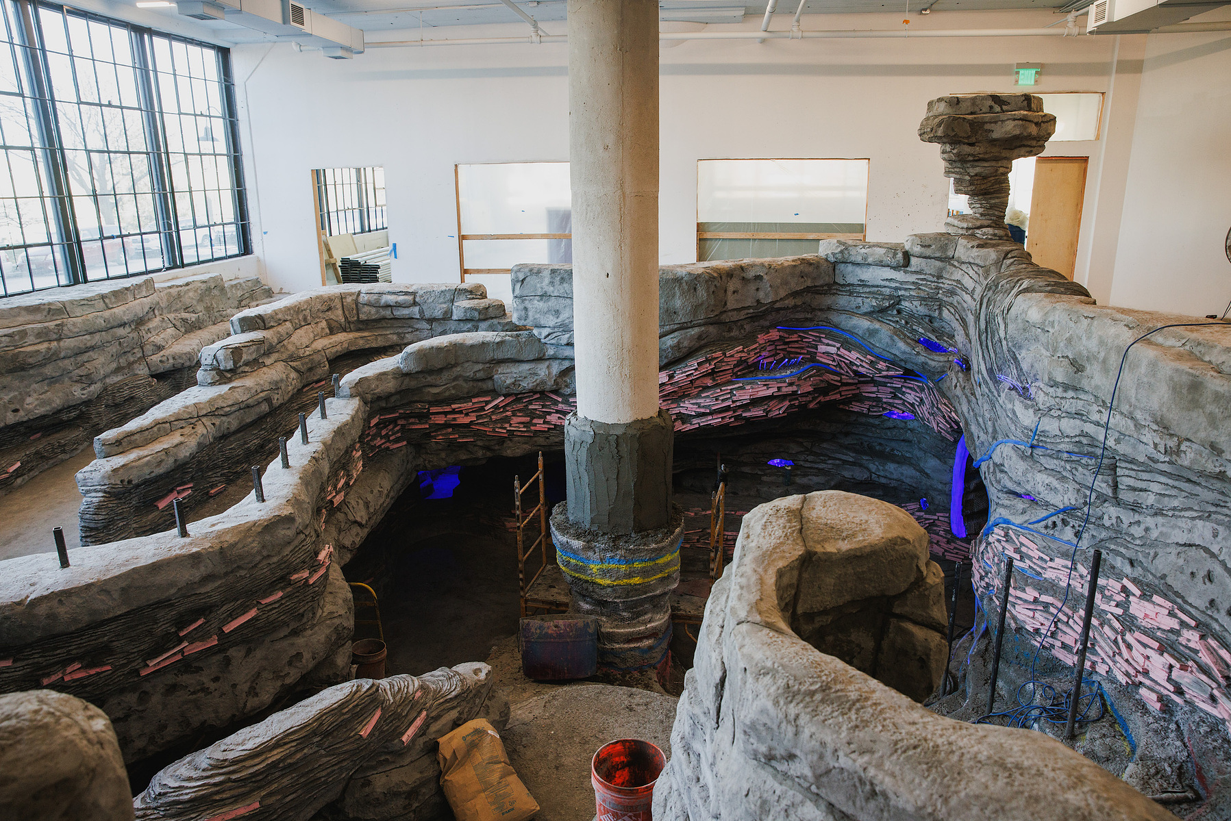 KANSAS CITY, MO – DECEMBER 07, 2023: A concrete rabbit burrow lined with books and lights serves as an entrance into The Rabbit Hole; an immersive museum in Kansas City, MO where people can experience scenes and characters from children’s literature. Cred