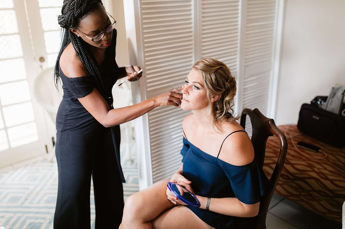 Best Jamaican makeup artist applying light weight foundation to bride