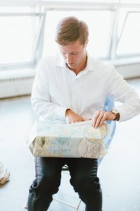 Groom opens up his gift upstairs at Artists for Humanity