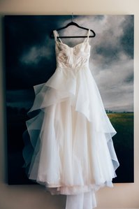 A soft romantic wedding at Regatta Place on Goat Island capturued on kodak film.  Floaty and dreamy wedding dress hanging on stormy picture in Newport.  Atmospheric Rhode Island Wedding shot on medium format film.