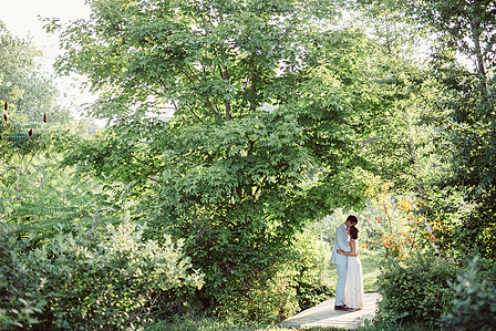 ​Bride and groom under the trees at  Quonquont Farm in Whately MA