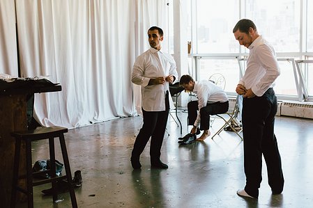 Groom and his friends get dressed upstairs at Artists for Humanity for his wedding day.