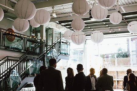 A wider view of wedding guests at Artists for Humanity in Boston.
