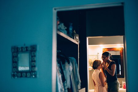 A Boston bride having her makeup done in her apartment