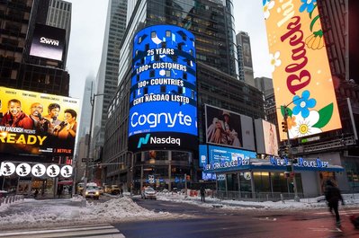 Times Square NASDAQ billboard screen showcasing a company going public in NYC