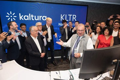 company employees celebrating company IPO at NASDAQ