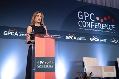 Company executive gives a speech behind a podium at company's annual conference