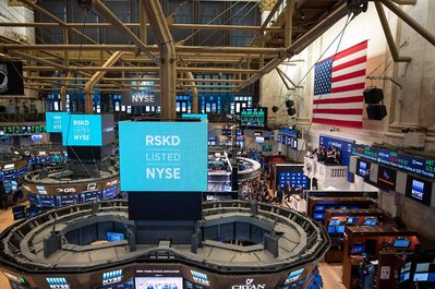 company celebrating going live at the New York Stock Exchange from the balcony 