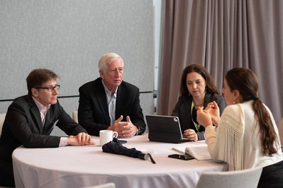 attendees of annual conference conversing around a round table during a break