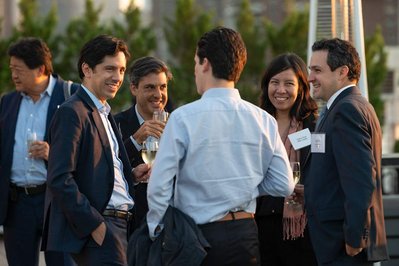 guests of a company's event are talking and laughing during an outdoors event