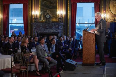 Former United states president Bill Clinton
at the podium giving a speech at a company conference at the president's club in NYC