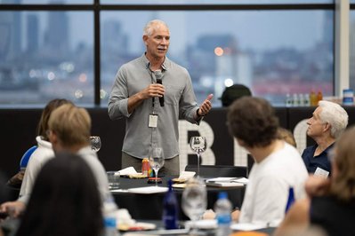 attendee in a company event asks a question using a microphone