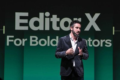 man presenting a company's product on stage at a company event