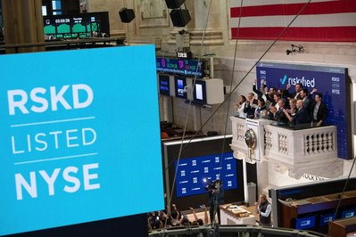 company celebrating going live at the New York Stock Exchange from the balcony 
