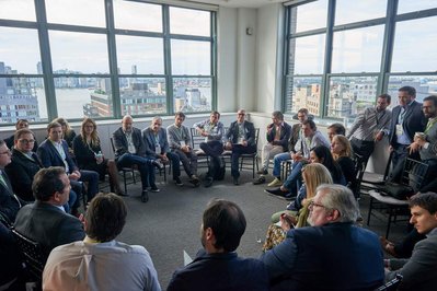 a circle of company conference attendees having a group session 