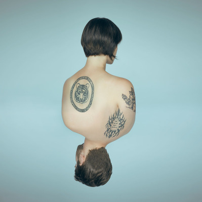 A composite of music duo Tiger + Man backs with tatoos