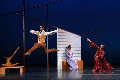 dancer jumping in the air, dancer sitting down in lilac dress and dancer reaching out in red dress 