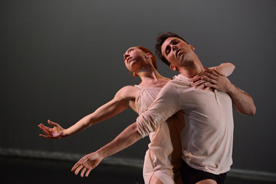 a close up of male and female dancers in an expressive moment