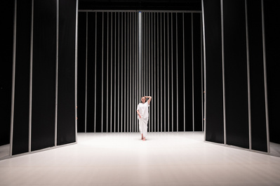 Irish blond female dancer in a large set made of vertical lines