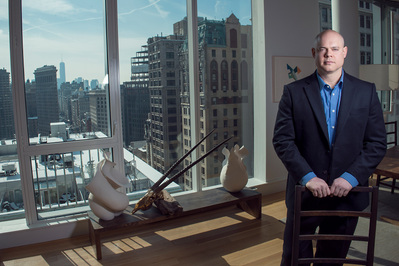 A corporate environmental portrait in the office next to a window with a NYC view