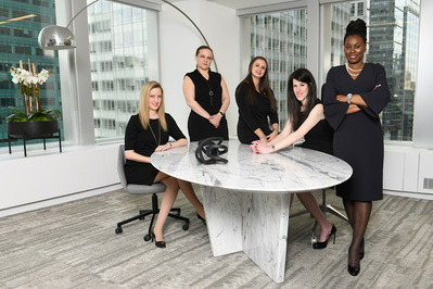 corporate businesswomen in an NYC office around a table